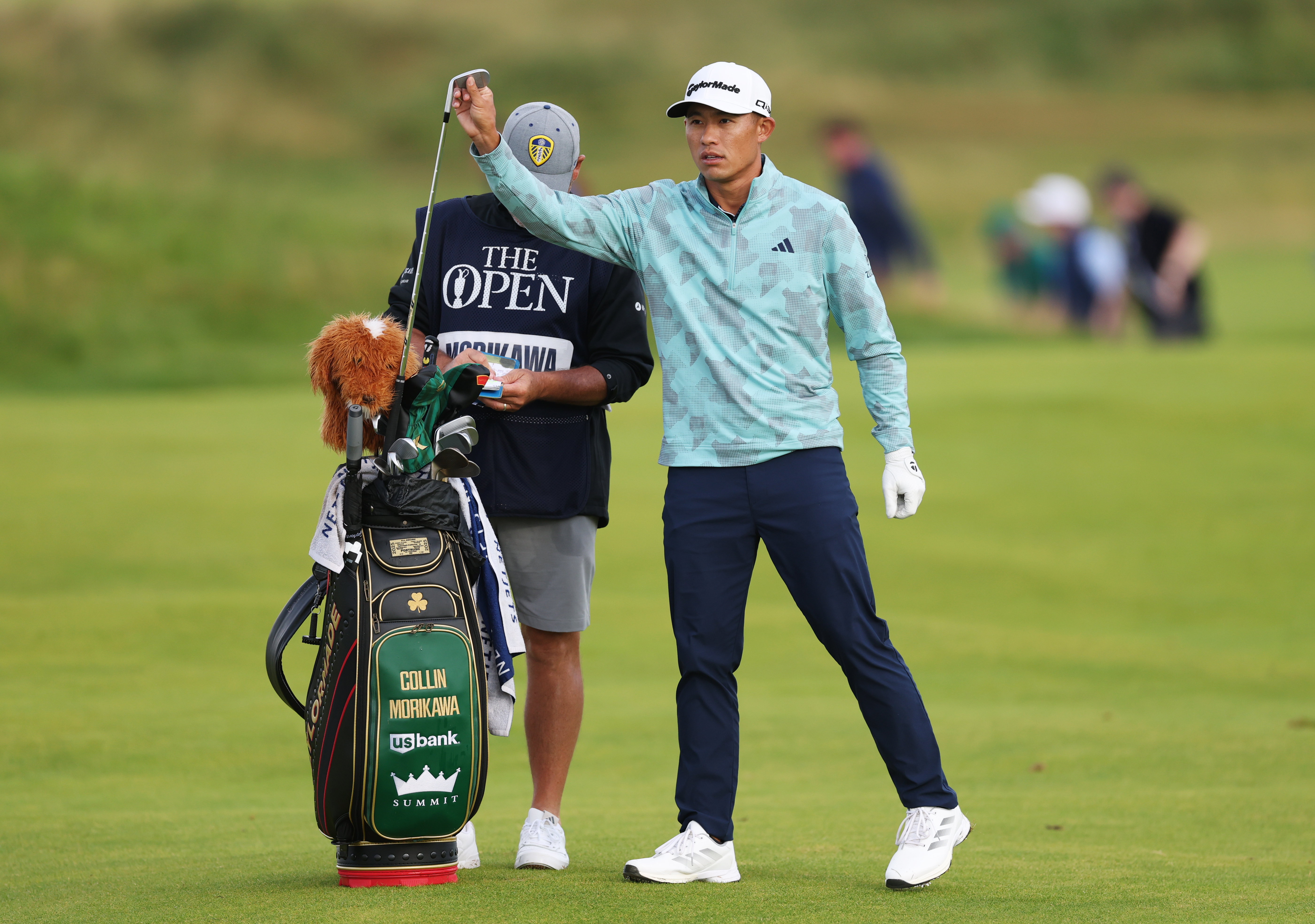 Collin Morikawa gets a club out his bag
