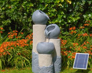 solar powered water feature with grey pots