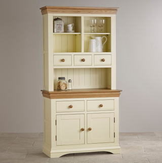 Country Cottage Natural Oak Painted Dresser in cream with wooden trim, with kitchen items on different shelves