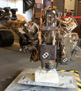 his photo taken in the "Mars Yard" at NASA's Jet Propulsion Laboratory, Pasadena, California, on Aug. 1, 2017, shows a step in development of possible alternative techniques that NASA's Curiosity Mars rover might be able to use to resume drilling into rocks on Mars.