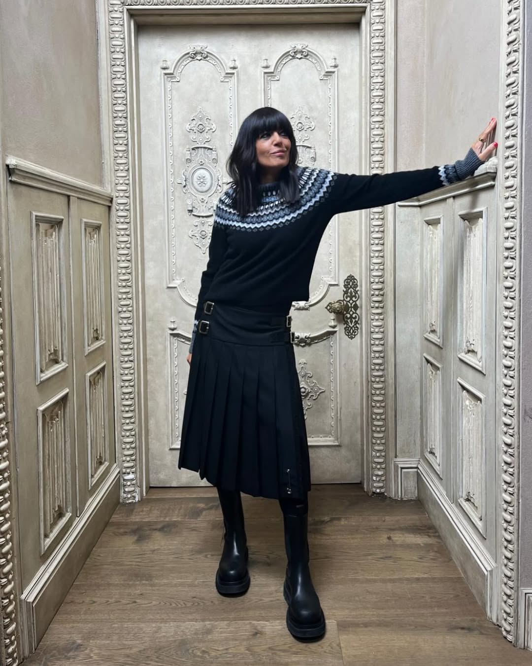 Claudia Winkleman wearing a fair isle jumper and black skirt