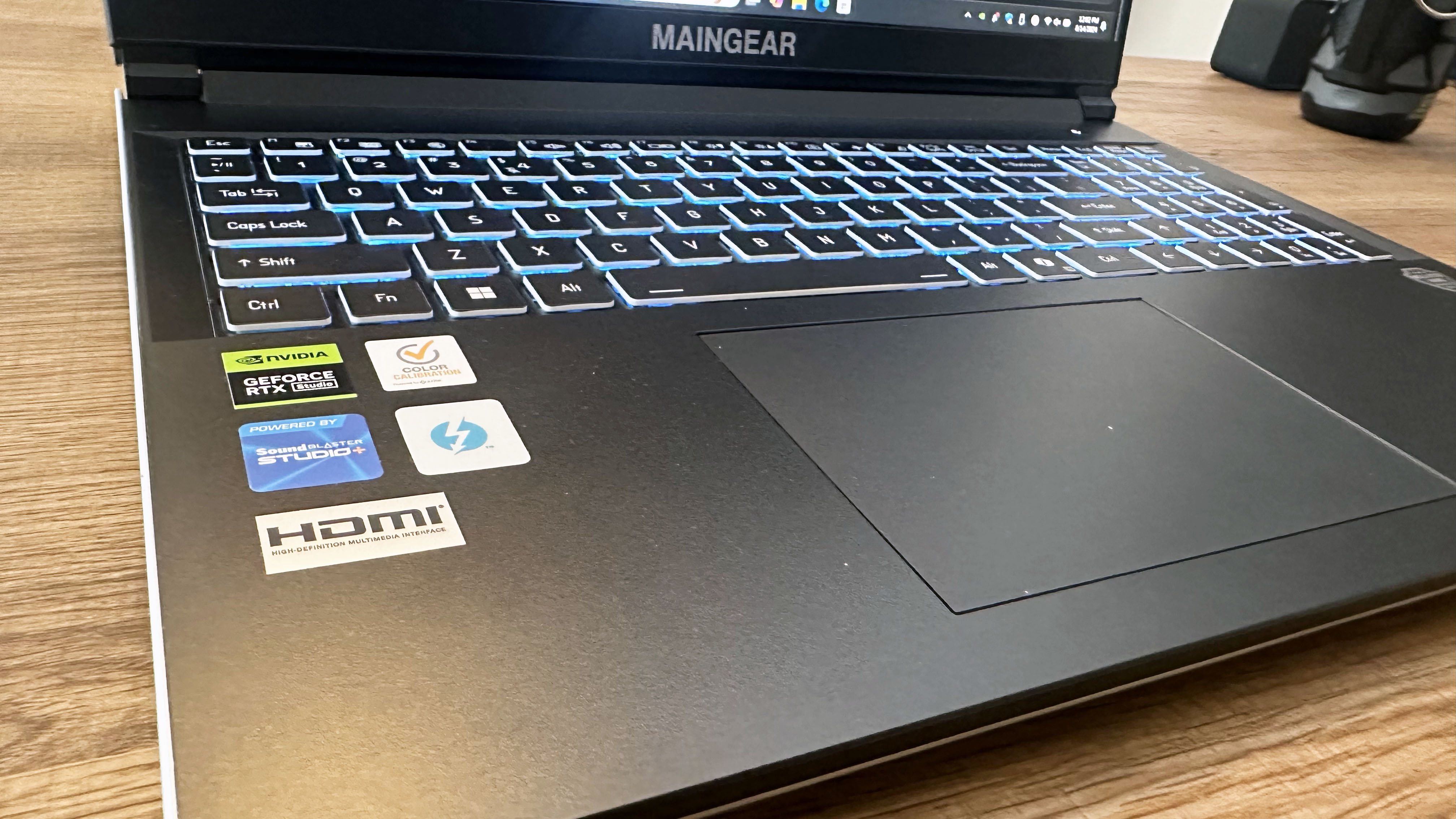 Angled close-up of the Maingear ML-16 gaming laptops keyboard and touchpad.