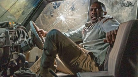 Dr. Nate Samuels (Idris Elba) looking panicked inside a smashed-up car in a scene from the survival thriller, "Beast" (2022)