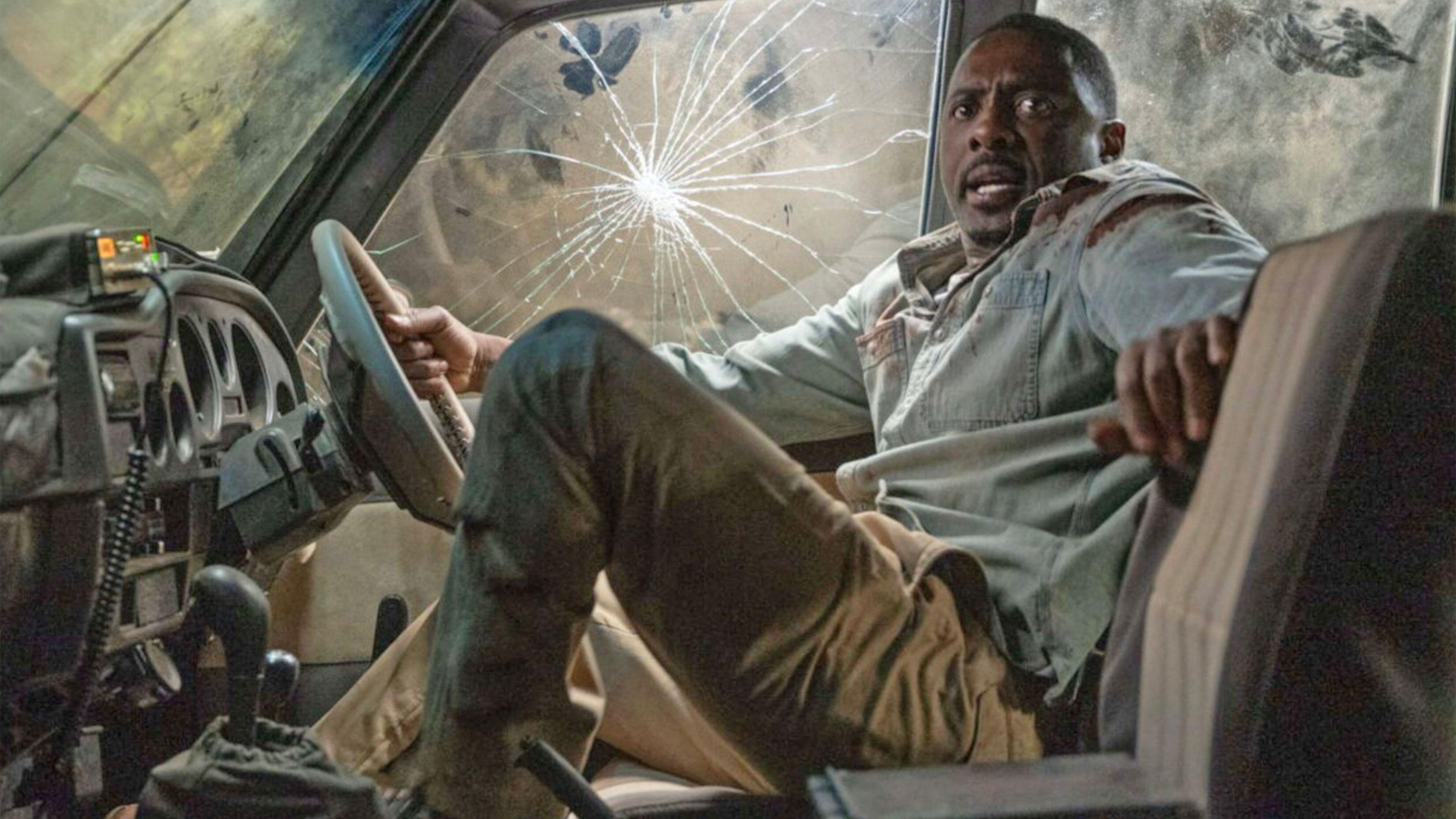 Dr. Nate Daniels (Idris Elba) looking panicked inside a smashed-up car in a scene from the survival thriller, "Beast" (2022)