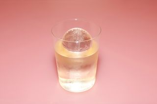 drink with spherical ice cube in