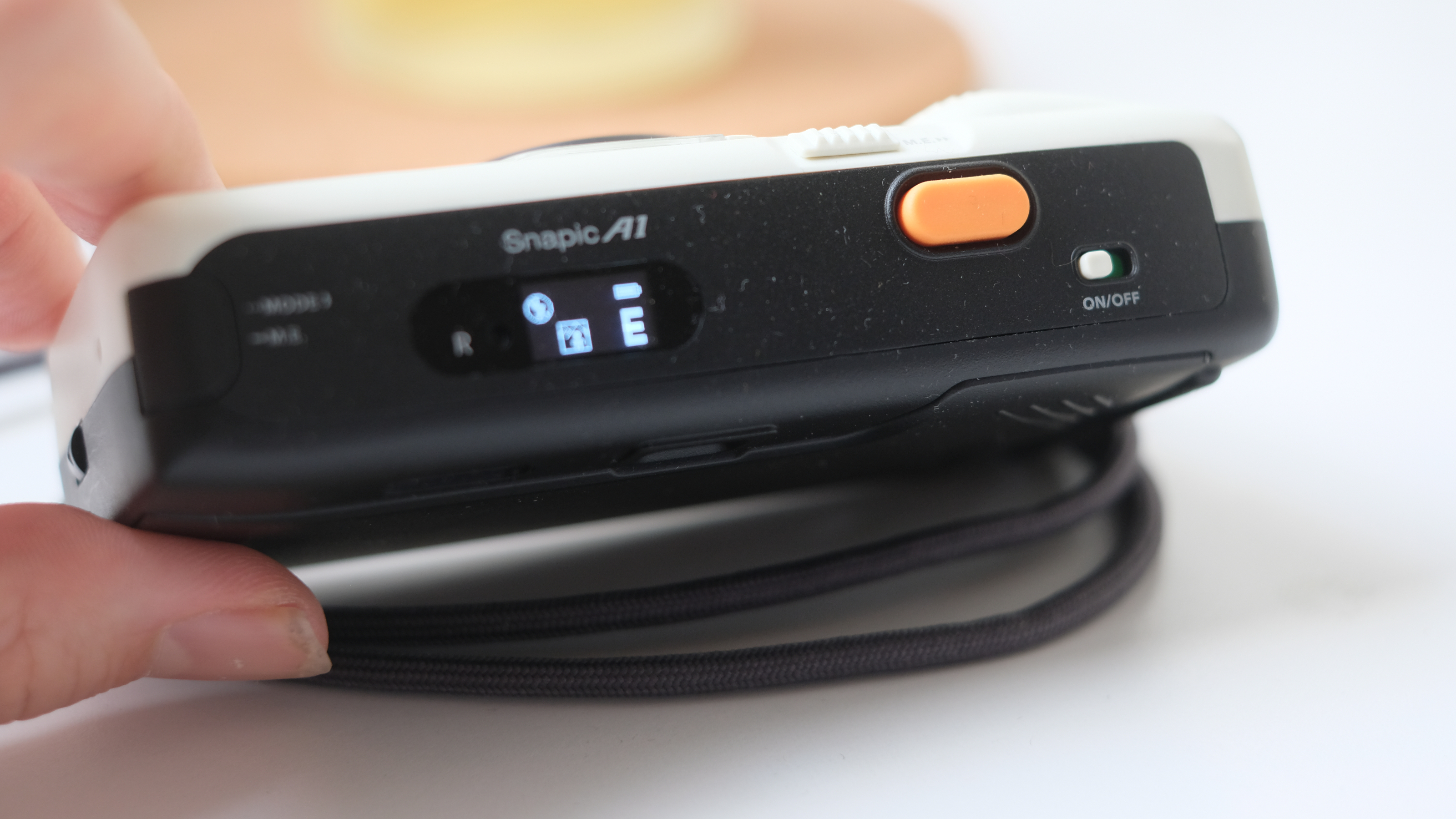 Photograph of Kodak Snapic A1 point-and-shoot film camera showing bright orange shutter button