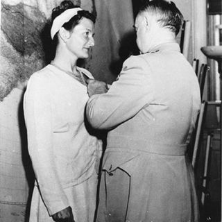 CIA agent Virginia Hall of Special Operations Branch receiving the Distinguished Service Cross from General Donovan, in September 1945.