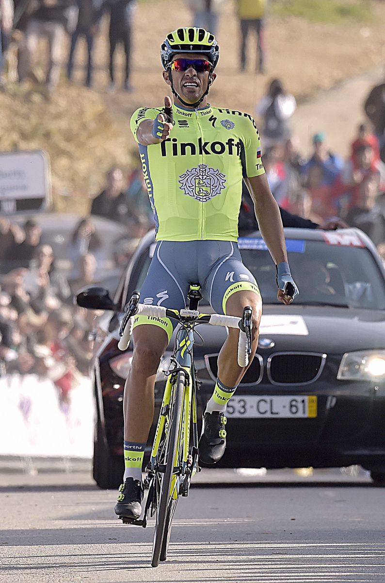Alberto Contador doing his signature 'pistolero' victory salute as he crosses the line