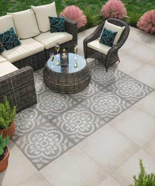 patio paved with a mix of plain and patterned tiles