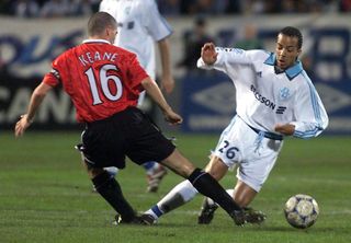 Roy Keane challenges Peter Luccin in Manchester United's Champions League game against Marseille in October 1999.