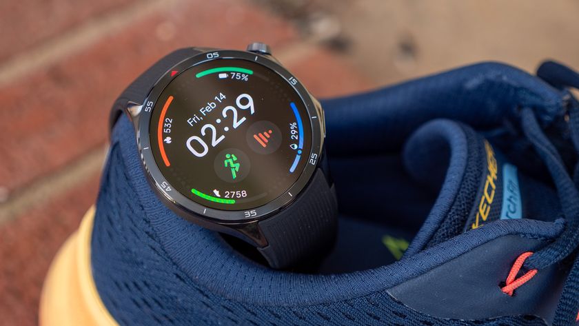 A OnePlus Watch 3 with a fitness watch face on a pair of workout shoes