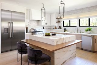 a modern with kitchen with a square marble island with seating