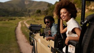 Man and woman in a safari truck