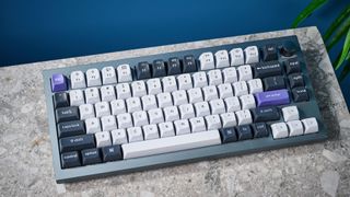 A photo of the Keychron Q1 Pro in gray aluminum with white, black and purple keycaps.