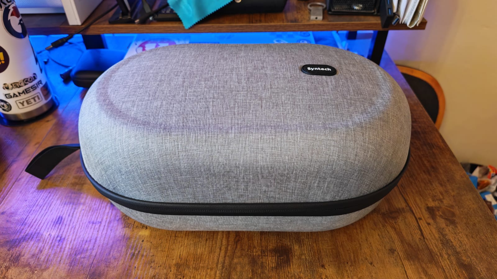 The Syntech Hard Carrying Case for Quest 3 closed on a gaming desk