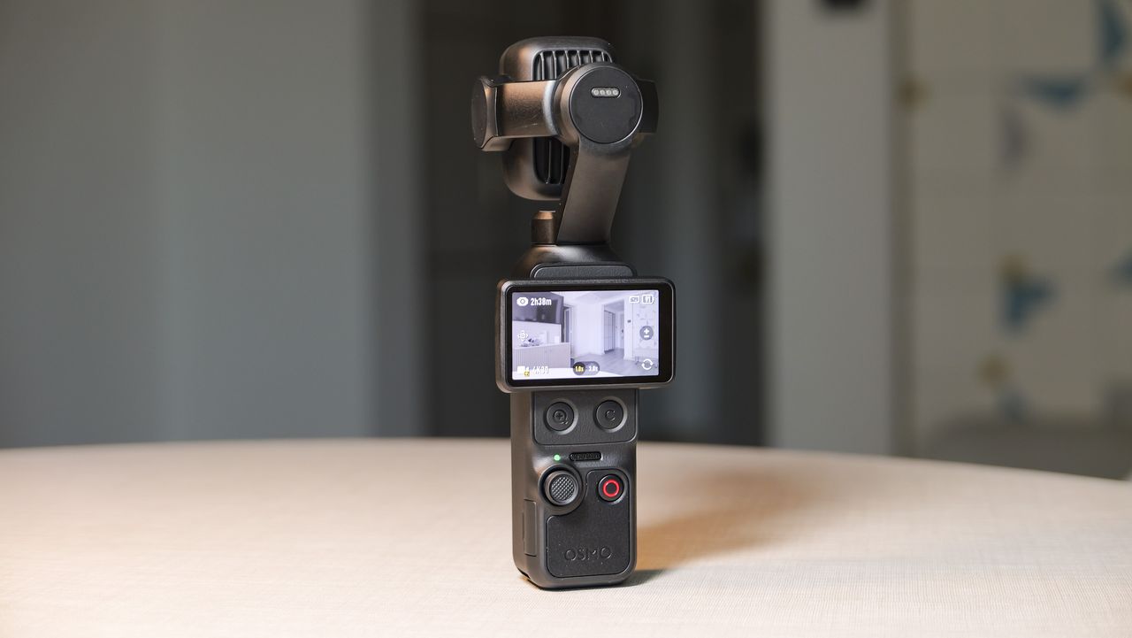 DJI Osmo Pocket 4P vlogging camera on a white desk in modern room