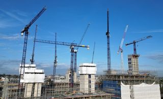 construction cranes building towers on construction site