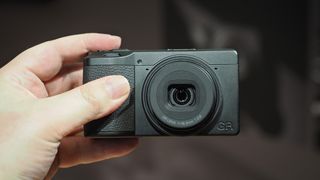 Ricoh GR IV Monochrome being held in hand