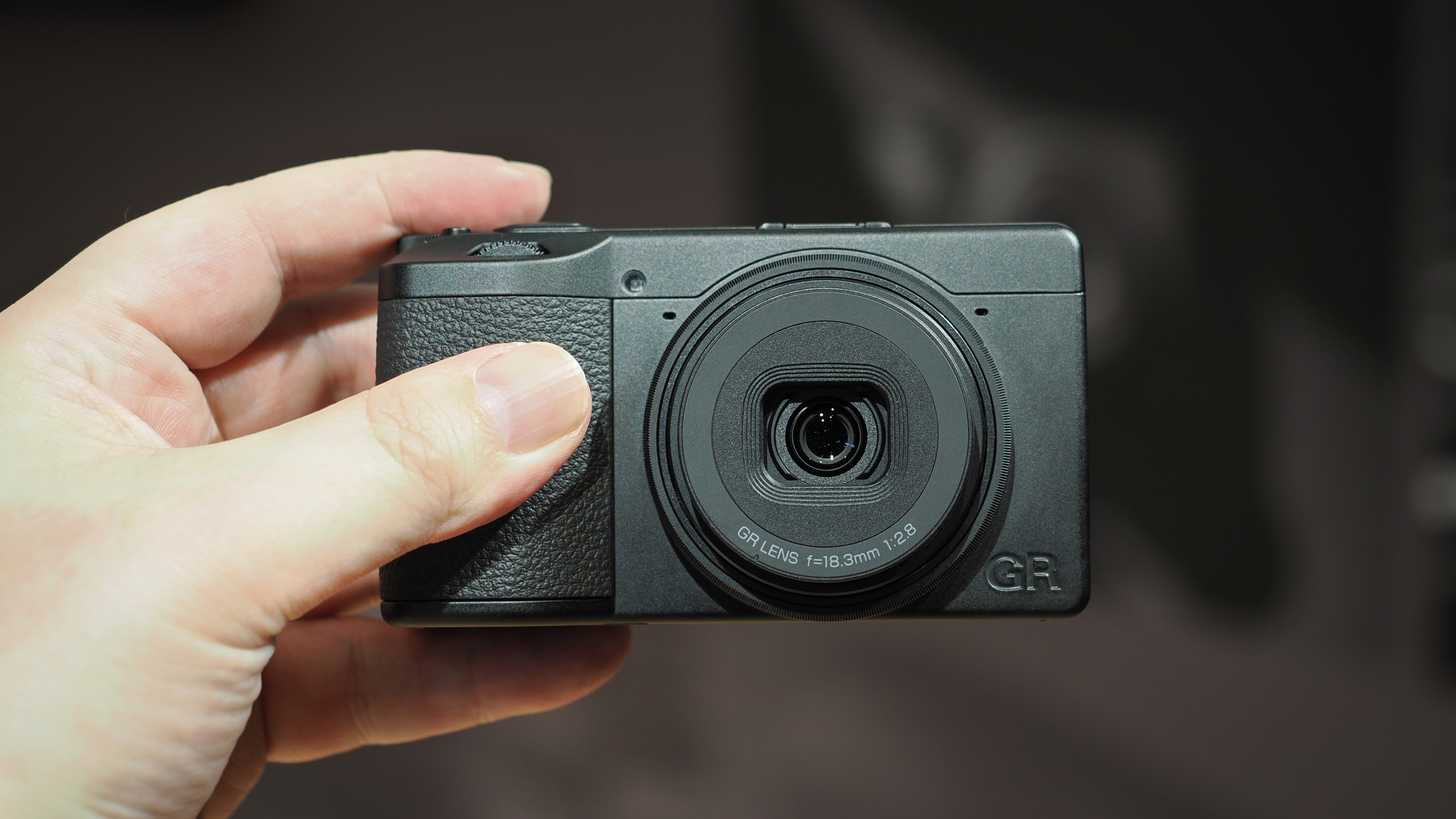 Ricoh GR IV Monochrome being held in hand
