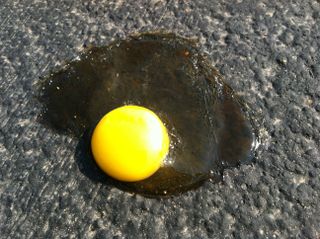 This egg spent 5 minutes in a fry pan on the sidewalk and then 20 minutes on the blacktop of the street in 112-degree heat in Phoenix, AZ on June 29, 2013. The egg white congealed a bit, but it did not fry.