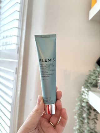 Mica Ricketts holding Elemis Pro-Collagen Skin Protection Fluid SPF50