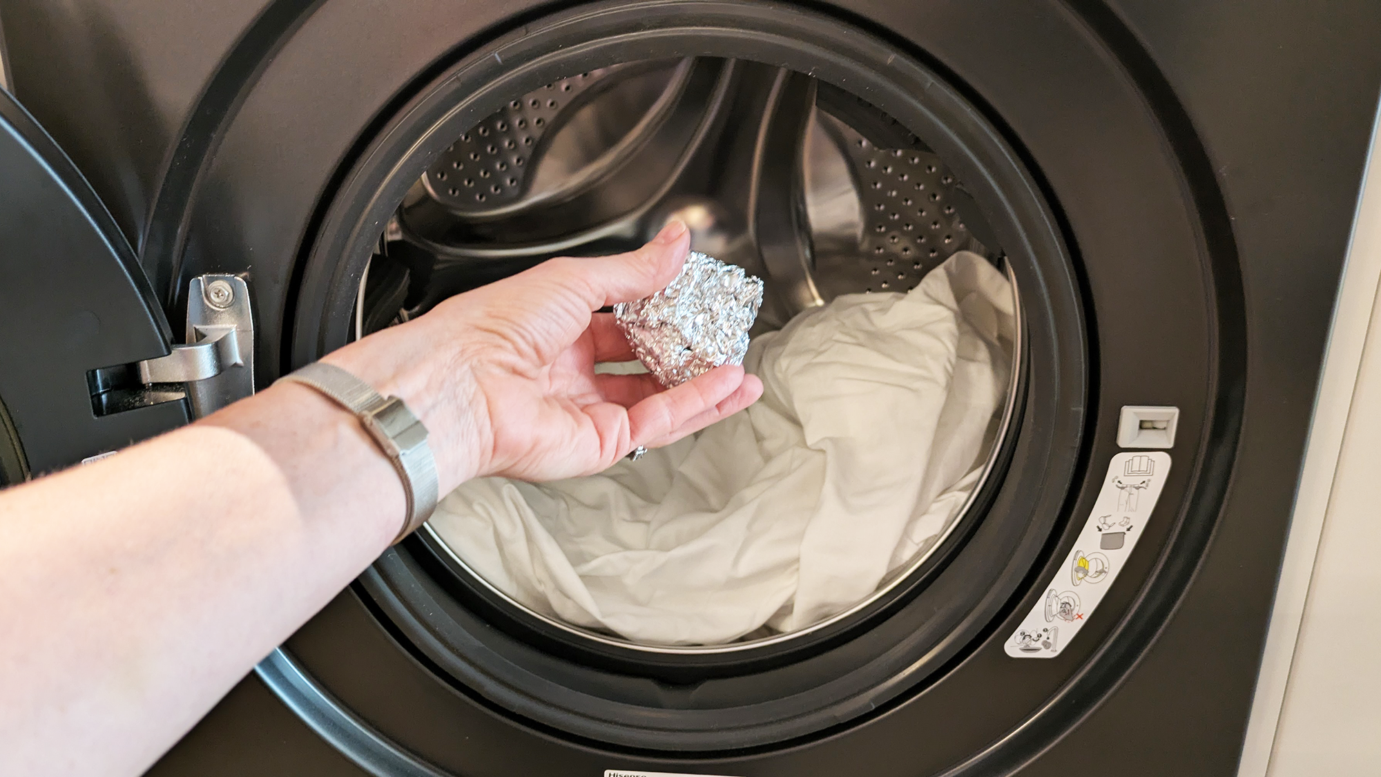 Putting ball of aluminum foil in washing machine