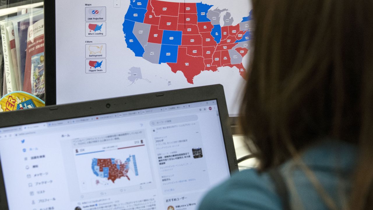 A trader watches an election map as results roll in.