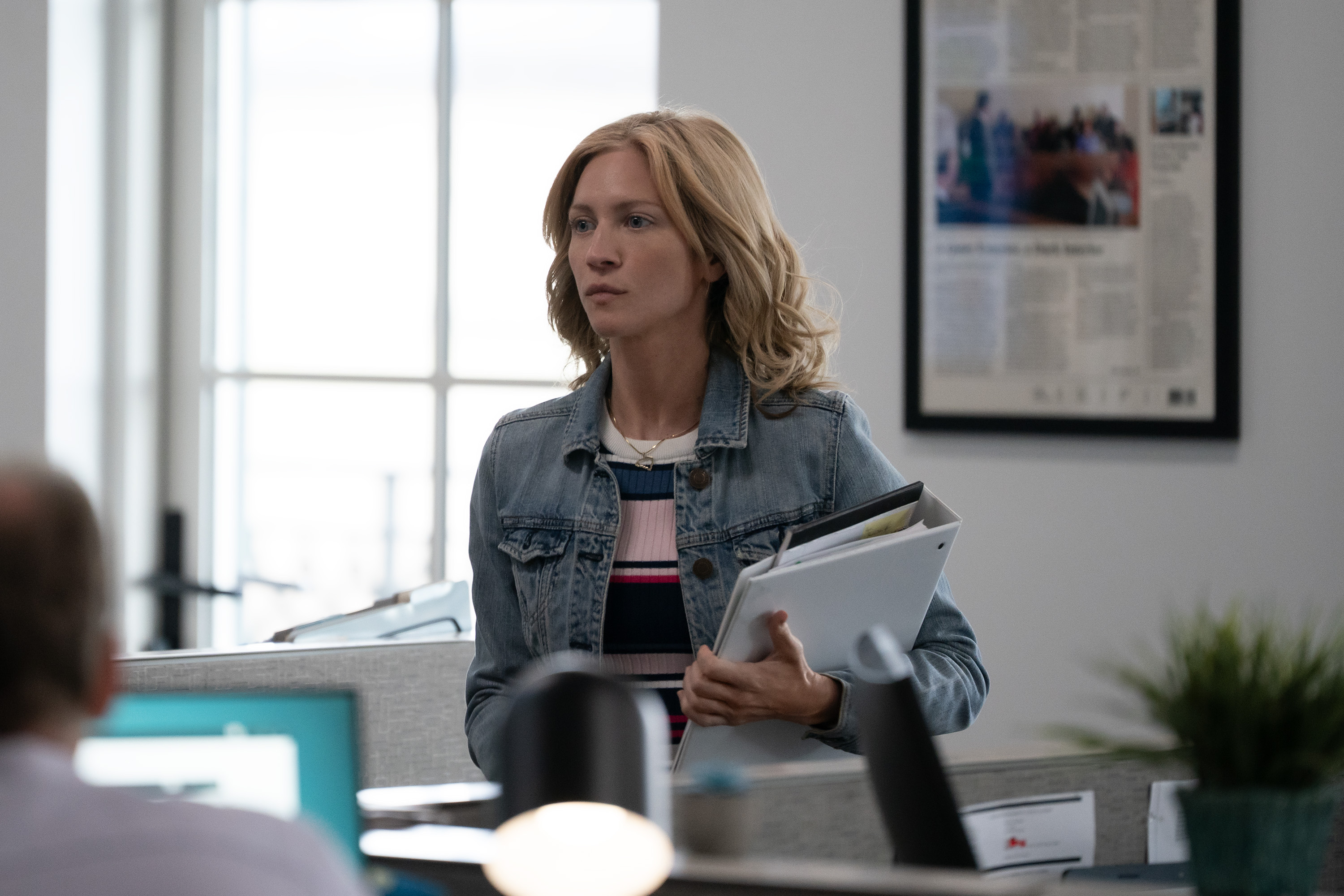 brittany snow as Mandy Matney walking through an office holding binders in murdaugh a death in the family