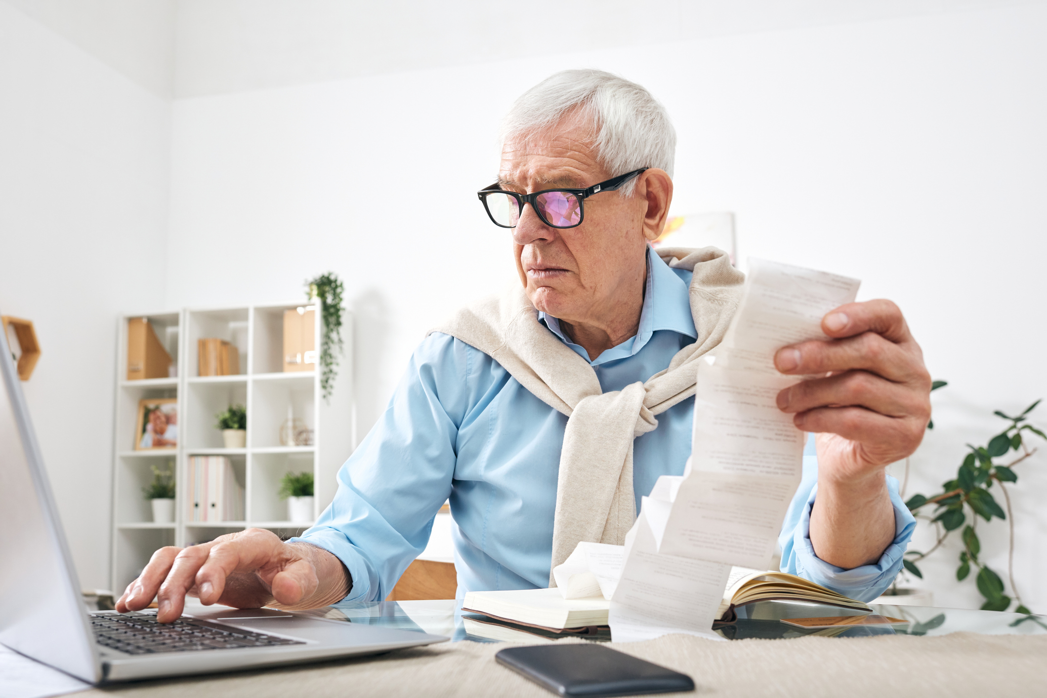 older man paying taxes