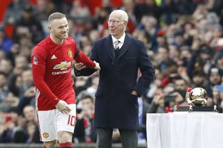 Rooney, left, alongside Sir Bobby Charlton during his trophy presentation for becoming Manchester United’s all-time leading goalscorer