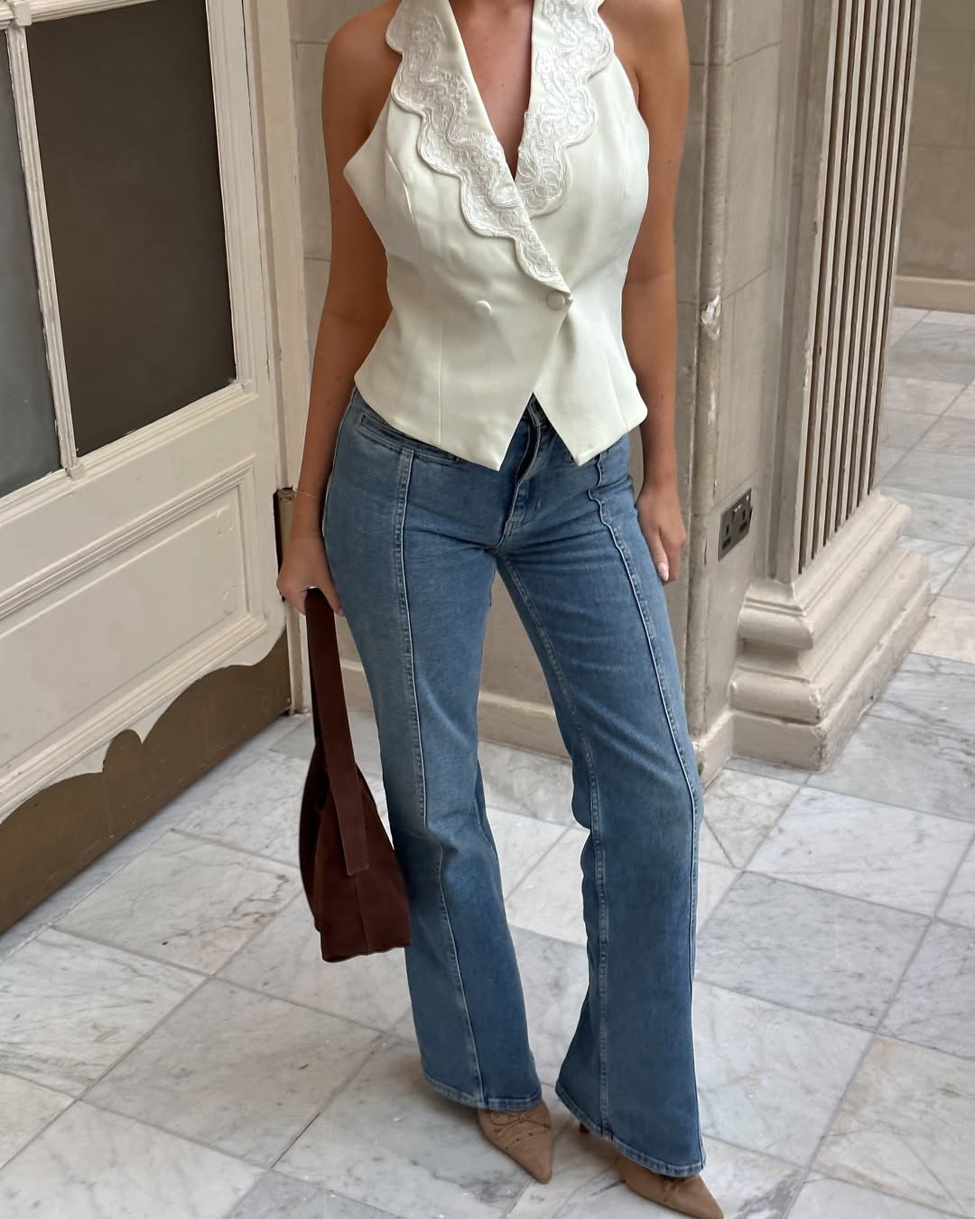 Woman wearing fall brown suede bag trend.