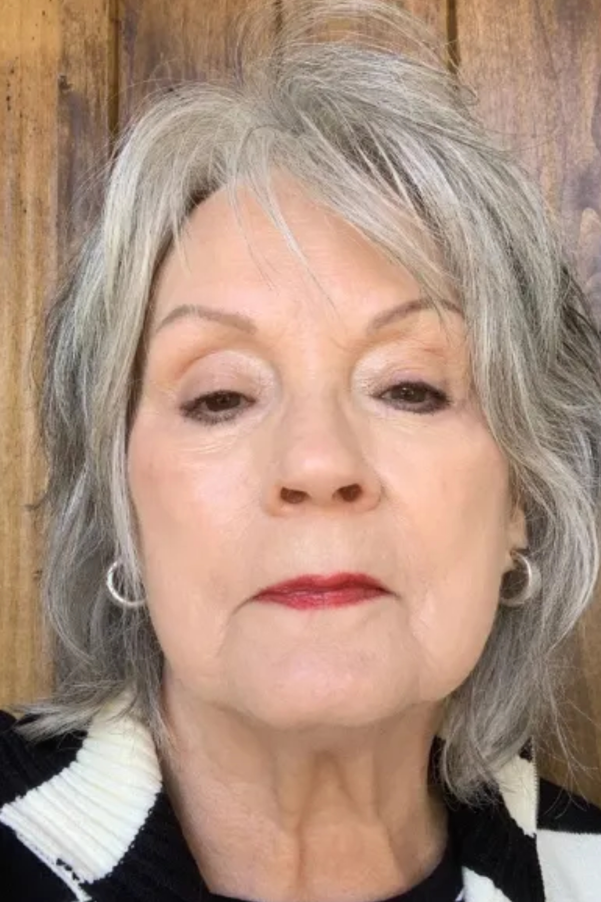 Jackie Witherow after applying Chanel Ultra Le Teint Ultrawear All Day Comfort Flawless Finish Foundation to her face with a black and white sweater.