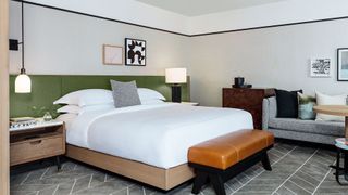 What mattresses do hotels use: image shows the Kimpton Bed placed on a light brown wooden bed frame at the Kimpton Sylvan Hotel