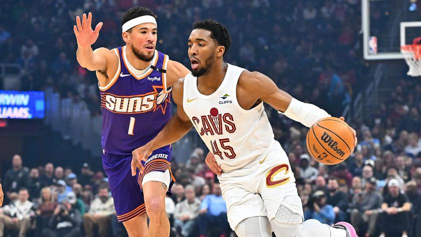 CLEVELAND, OHIO - JANUARY 20: Donovan Mitchell #45 of the Cleveland Cavaliers brings the ball up court around Devin Booker #1 of the Phoenix Suns during the first quarter at Rocket Mortgage Fieldhouse on January 20, 2025 in Cleveland, Ohio. NOTE TO USER: User expressly acknowledges and agrees that, by downloading and or using this photograph, User is consenting to the terms and conditions of the Getty Images License Agreement. (Photo by Jason Miller/Getty Images)