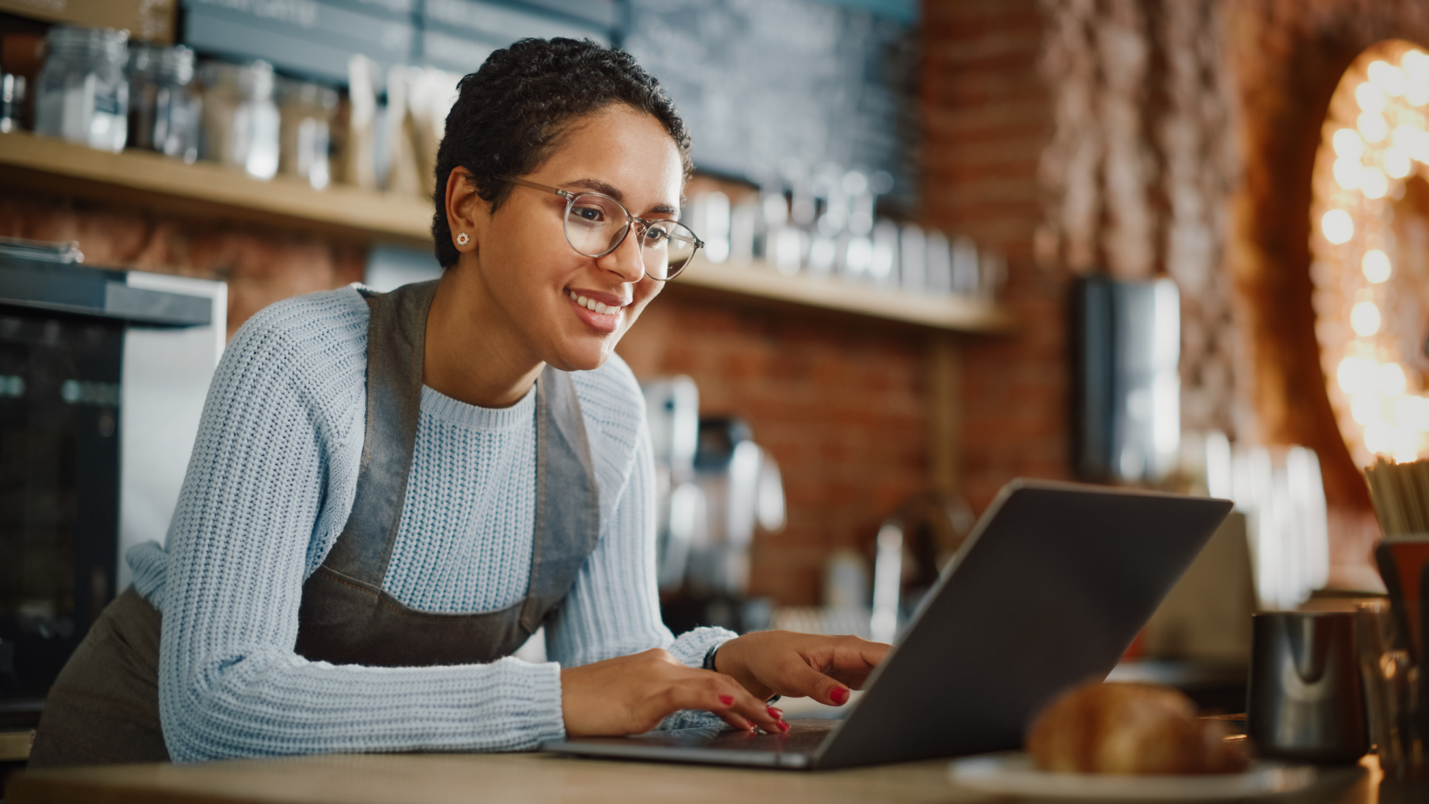 Woman using laptop in a cafe