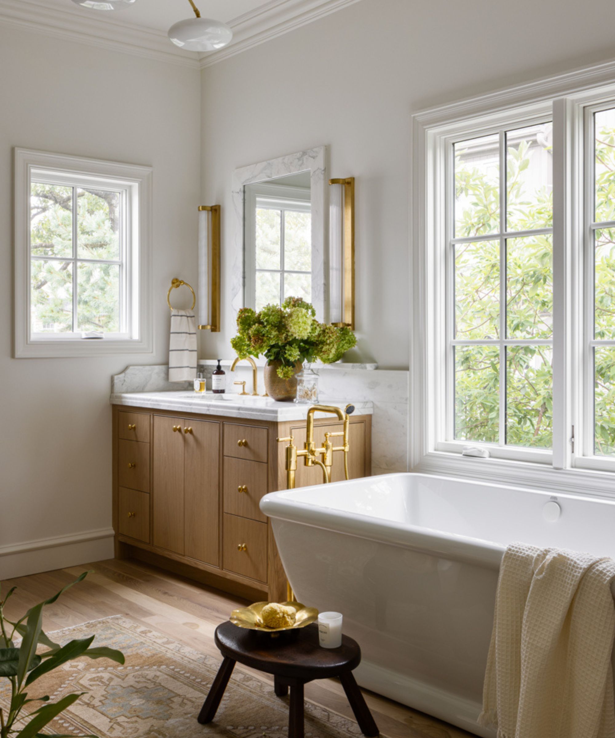 A white and wood bathroom with a freestanding bath