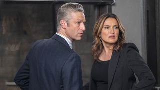 Peter Scanavino as A.D.A Sonny Carisi and Mariska Hargitay as Captain Olivia Benson standing next to each other in Law & Order: SVU season 24
