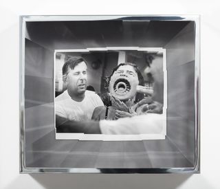 Multi-faceted acrylic boxes frame and distort archival photographs of people