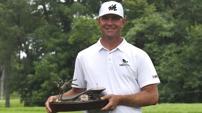 Lucas Glover poses with the trophy after winning the 2021 John Deere Classic