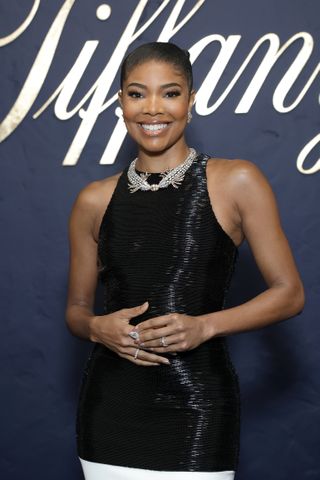 Gabrielle Union wearing a black dress with a diamond necklace