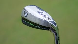 wilson launch pad 2022 iron on a green background showing its thick sole