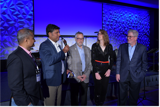 Prashant Maru, vice president of sales at Saankhya Labs (left), and company CEO Parag Naik are joined by former ATSC president Mark Richer, current president Madeleine Noland and board chair Richard Friedel for the presentation of the Mark Richer Industry Leadership Medal.