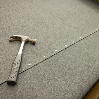 newly felted shed roof with hammer and colt nails