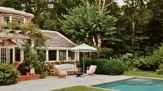 cottage backyard with pool and parasol