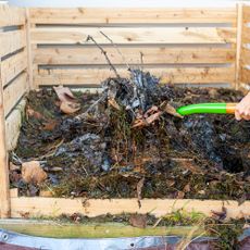 Wooden garden compost being turned