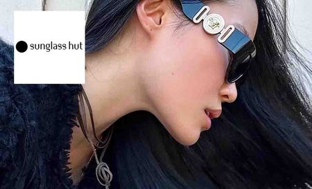 Sunglasses hut logo placed over an image of a side profile of a woman wearing sunglasses