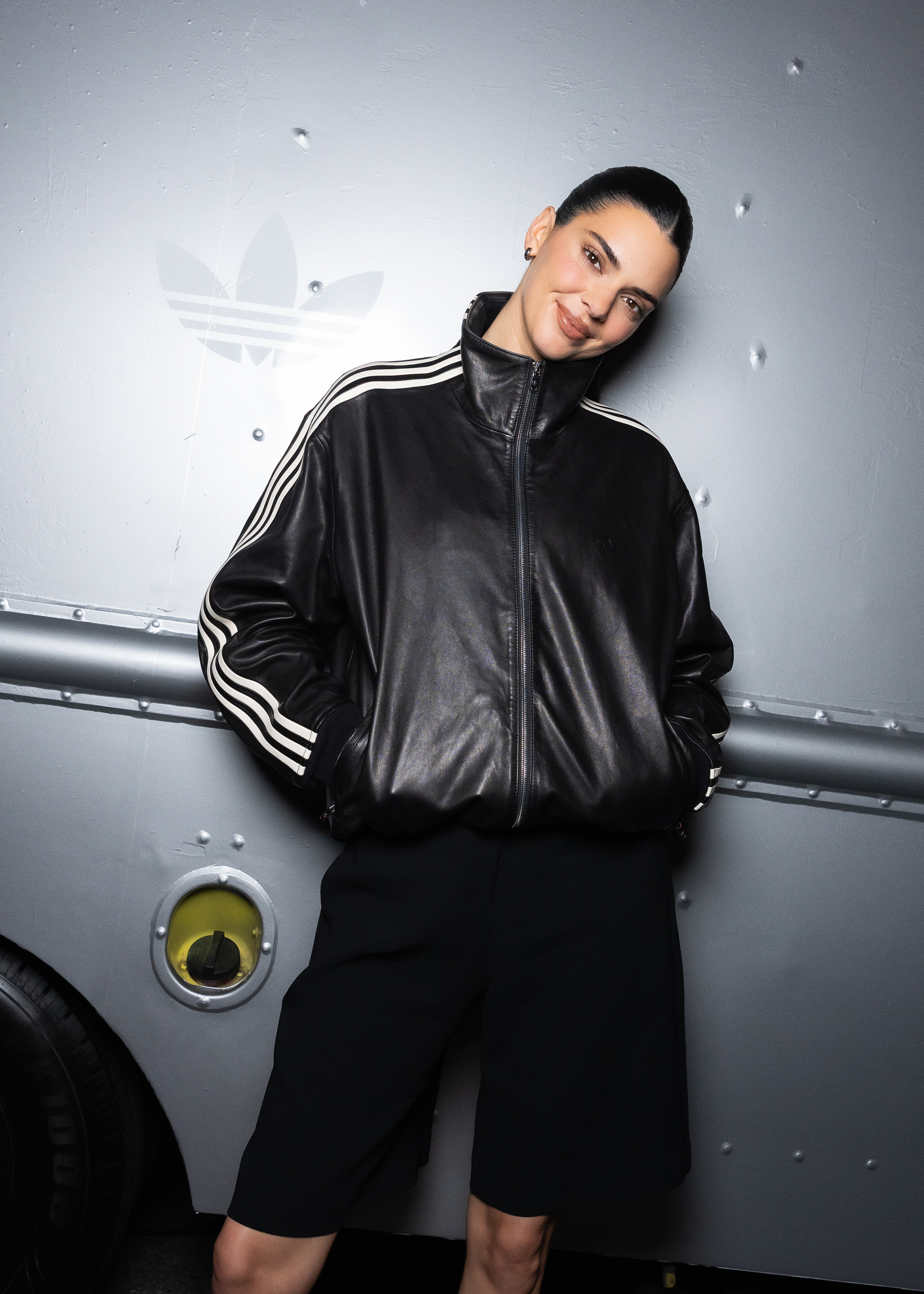 Kendall Jenner attended an Adidas event in a leather take on the track jacket trend and elongated Bermuda shorts