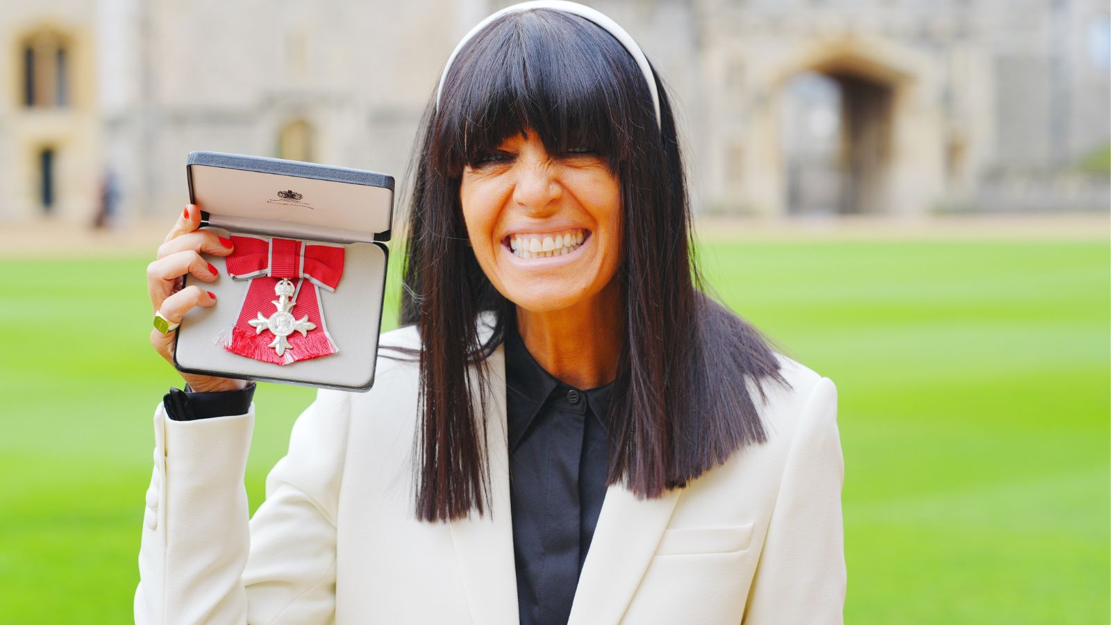 Claudia Winkleman holding her MBE
