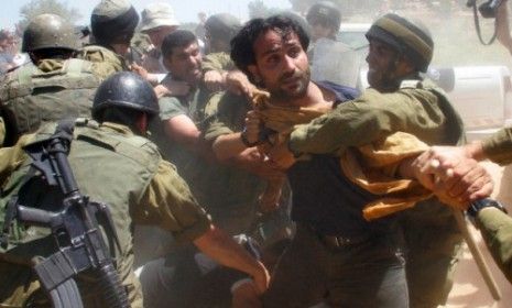 Palestinian, Israeli and foreign demonstrators scuffle with Israeli soldiers during a protest against Israeli&amp;#039;s barrier in Bethlehem.