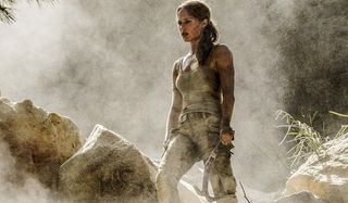 Tomb Raider Alicia Vikander Lara stands armed with axe